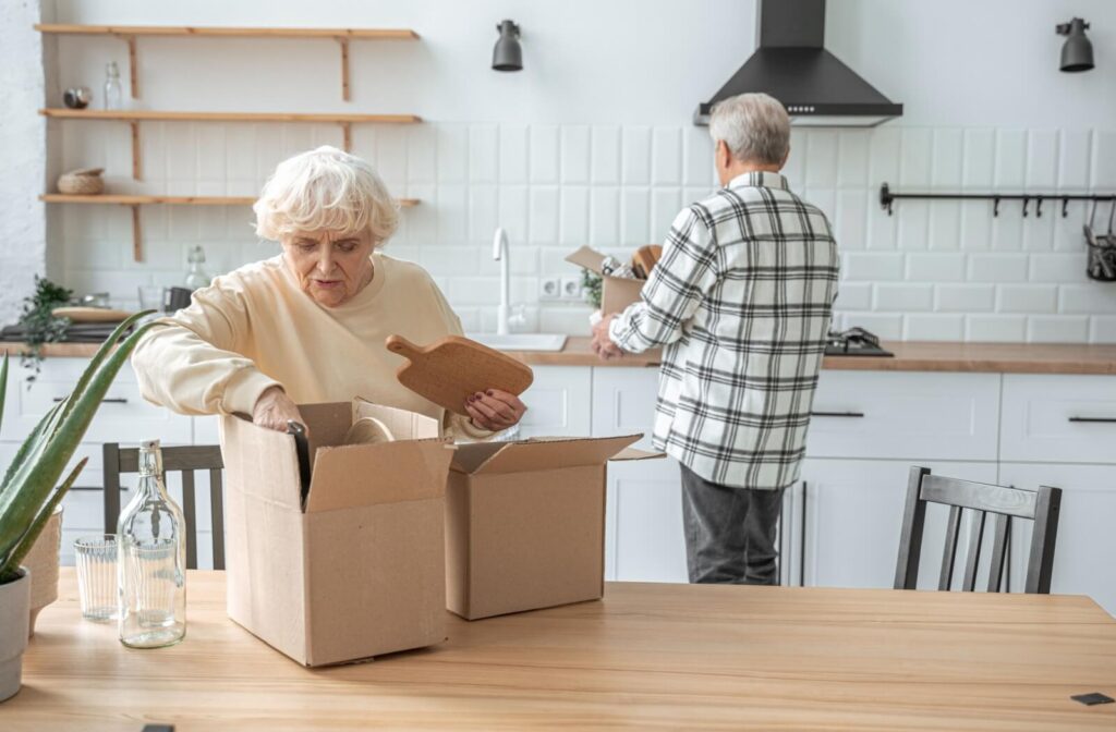 An older married couple packing up their kitchen during a move to independent living.